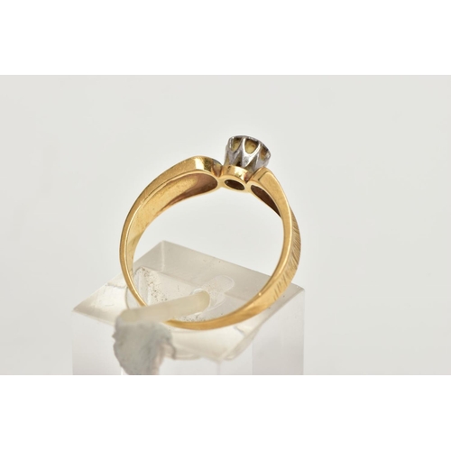 4 - A YELLOW METAL DIAMOND RING, a single round brilliant diamond, set in a white metal illusion setting... 