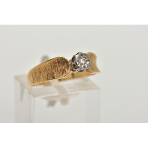 4 - A YELLOW METAL DIAMOND RING, a single round brilliant diamond, set in a white metal illusion setting... 