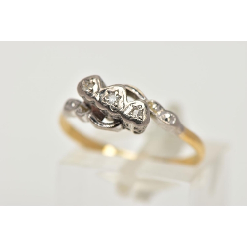 5 - A WHITE AND YELLOW METAL DIAMOND RING,  a single round brilliant cut diamond and two rose cut diamon... 