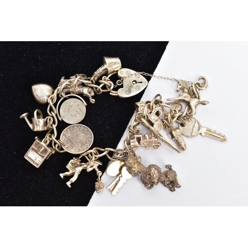 83 - A SILVER CHARM BRACELET TWO SILVER COINS AND A COMPACT, curb link bracelet each link stamped sterlin... 