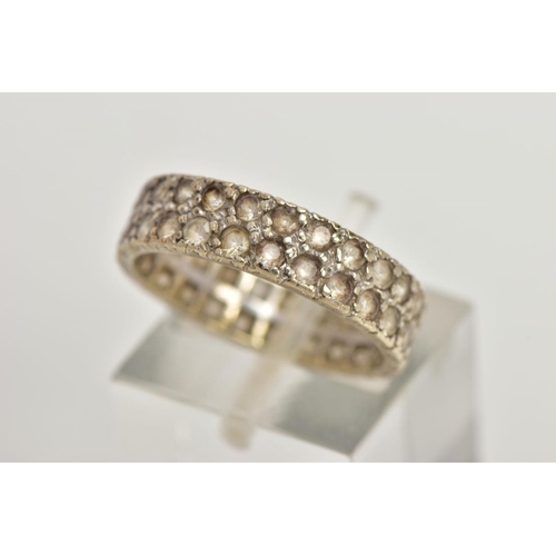 84 - A WHITE METAL FULL ETERNITY RING, wide band set with two rows of colourless spinels, approximate wid... 