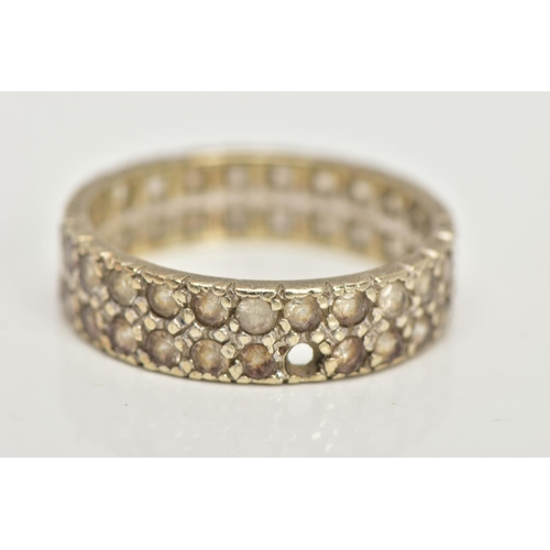 84 - A WHITE METAL FULL ETERNITY RING, wide band set with two rows of colourless spinels, approximate wid... 