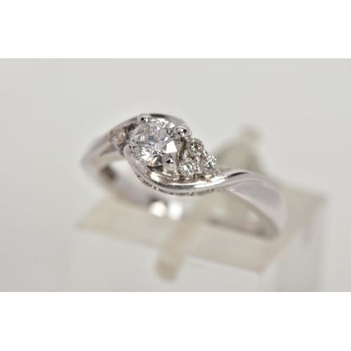 86 - AN 18CT WHITE GOLD DIAMOND RING, the brilliant cut diamond with asymmetric brilliant cut diamond tre... 