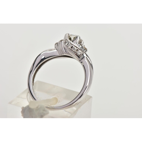 86 - AN 18CT WHITE GOLD DIAMOND RING, the brilliant cut diamond with asymmetric brilliant cut diamond tre... 