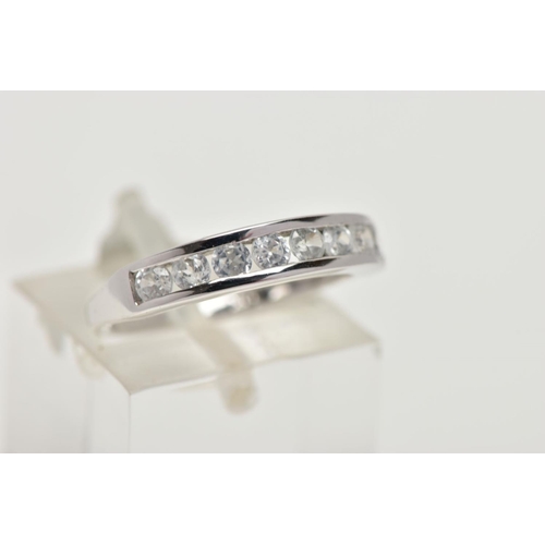 91 - A 9CT GOLD HALF ETERNITY RING, a white gold band ring, channel set with eight circular cut colourles... 