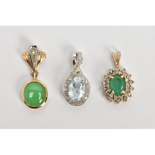 92 - TWO YELLOW METAL PENDANTS AND A WHITE METAL PENDANT, the first an oval cut emerald set with a cluste... 