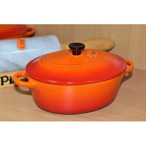 535 - A PAIR OF LE CREUSET ORANGE GLAZED OVAL CERAMIC  INDIVIDUAL CASSEROLE DISHES AND COVERS, impressed m... 