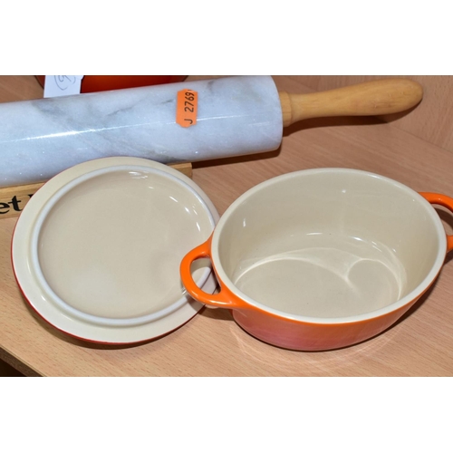 535 - A PAIR OF LE CREUSET ORANGE GLAZED OVAL CERAMIC  INDIVIDUAL CASSEROLE DISHES AND COVERS, impressed m... 