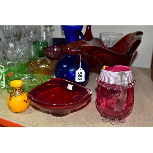 563 - A GROUP OF COLOURED AND CLEAR GLASSWARES, to include a cranberry glass jug with white rim detail and... 