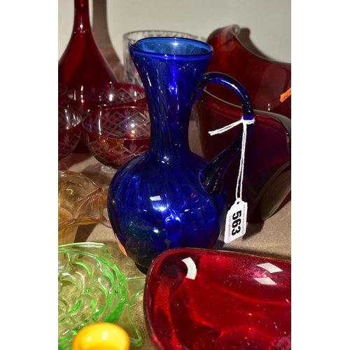 563 - A GROUP OF COLOURED AND CLEAR GLASSWARES, to include a cranberry glass jug with white rim detail and... 