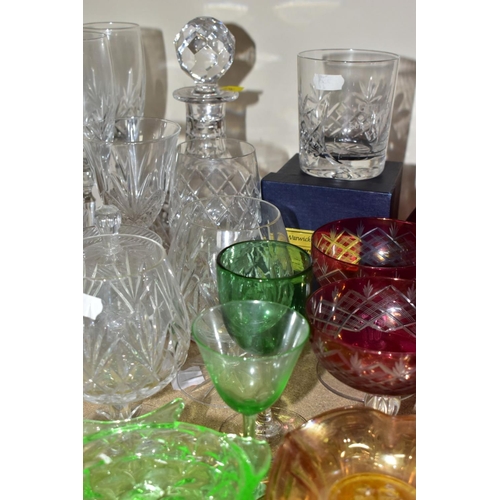 563 - A GROUP OF COLOURED AND CLEAR GLASSWARES, to include a cranberry glass jug with white rim detail and... 