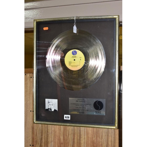 628 - A MADONNA PLATINUM DISC SALES AWARD, the plaque reading 'Presented to Pat Purcell to commemorate the... 