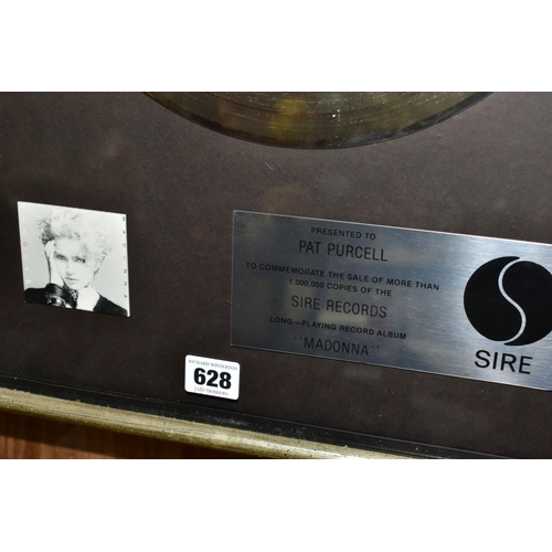 628 - A MADONNA PLATINUM DISC SALES AWARD, the plaque reading 'Presented to Pat Purcell to commemorate the... 