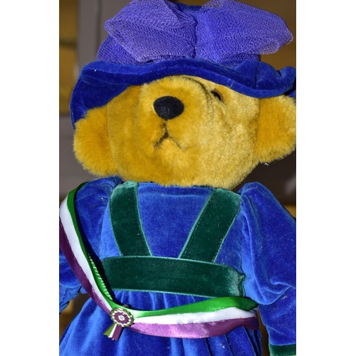 654 - MERRYTHOUGHT: A TEDDY BEAR DRESSED AS A SUFFRAGETTE, sporting a sash of suffragette colours with ena... 