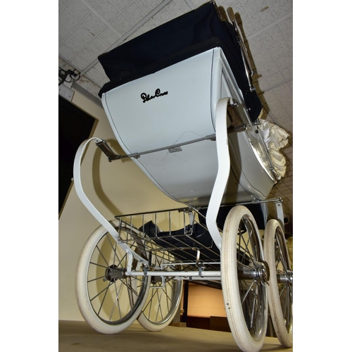 671 - A SILVER CROSS COACH BUILT DOLL'S PRAM IN WHITE WITH NAVY BANDING, with folding hood, removable cove... 