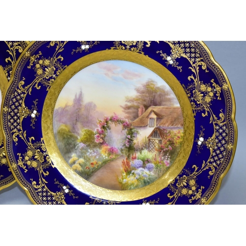 711 - TWO ROYAL WORCESTER CABINET PLATES, printed and painted cottage scenes to the centres, borderd by co... 