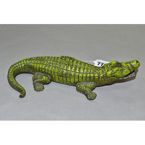 772 - A VINTAGE CAST IRON CIGARETTE/VESTA CASE, in the form of a crocodile, with hinged lid revealing inte... 