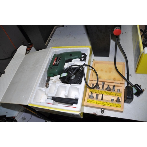 1303 - A BOSCH RT60 ROUTER TABLE, a Bosch POF500A router, a Bosch SB400-2 Drill, a Bosch PSR14,4 cordless d... 