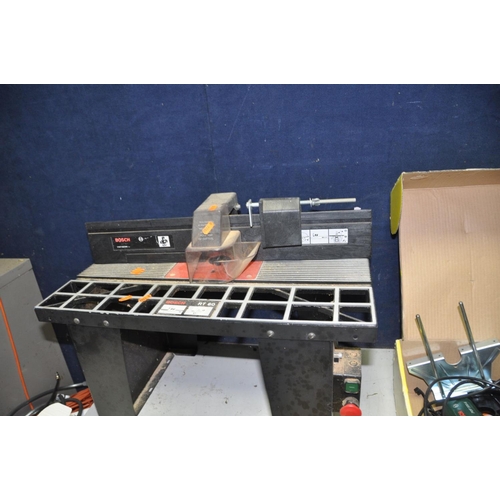 1303 - A BOSCH RT60 ROUTER TABLE, a Bosch POF500A router, a Bosch SB400-2 Drill, a Bosch PSR14,4 cordless d... 