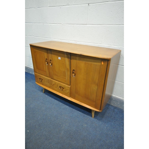 1433 - AN ERCOL MODEL 467 ELM AND BEECH SIDEBOARD, with double cupboard door above a single drawer, besides... 