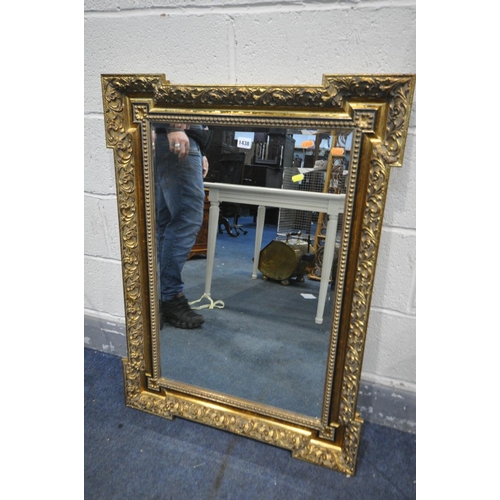 1438 - AN ATTEWELL GILTWOOD BEVELLED EDGE RECTANGULAR WALL MIRROR, with foliate border, ebonised trim and s... 