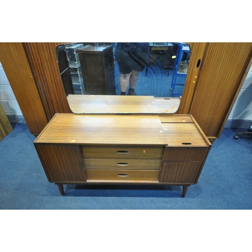 1445 - A MID-CENTURY AUSTINSUITE TEAK TAMBOUR DOOR BEDROOM SUITE, comprising dressing table with a single m... 