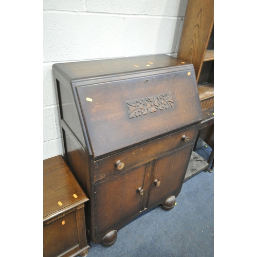 1447 - AN ART DECO OAK OPEN BOOKCASE, an oak occasional table, a fall front bureau, an oak blanket box, a d... 