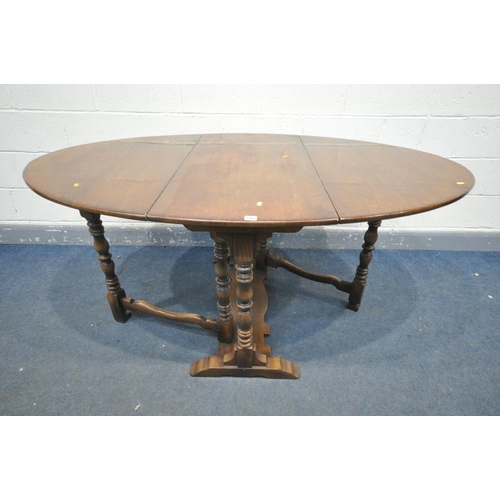 1461 - A REPRODUCTION OAK GATE LEG DINING TABLE, with turned legs, open length 168cm x closed length 55cm x... 