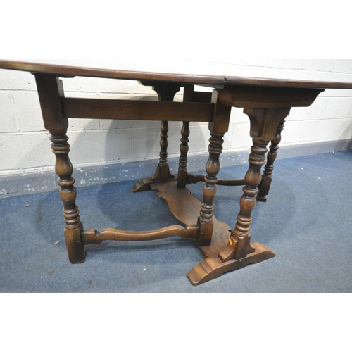 1461 - A REPRODUCTION OAK GATE LEG DINING TABLE, with turned legs, open length 168cm x closed length 55cm x... 