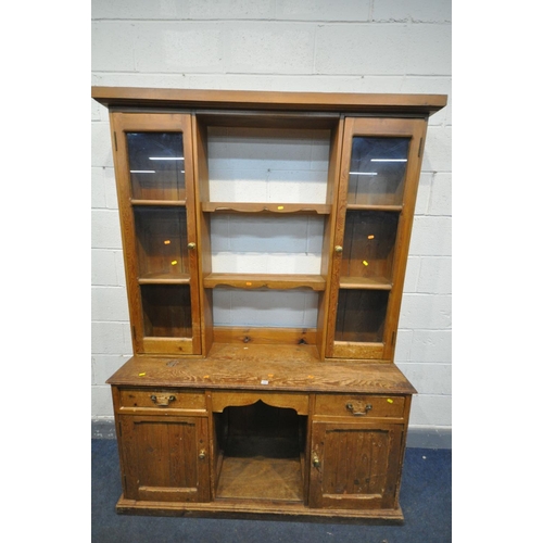 1502 - A 19TH CENTURY PINE DRESSER, the top with a two glazed cupboard doors, flanking two shelves, over a ... 