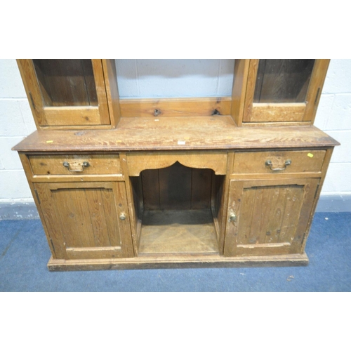 1502 - A 19TH CENTURY PINE DRESSER, the top with a two glazed cupboard doors, flanking two shelves, over a ... 