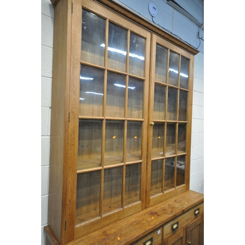 1505 - A 19TH CENTURY PITCH PINE FARMHOUSE BOOKCASE, the upper section with double astragal glazed doors, e... 