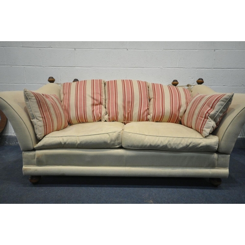 1508 - A KNOWLE STYLE CREAM UPHOLSTERED TWO SEATER SOFA, with tie back drop arms, on turned legs, width 195... 