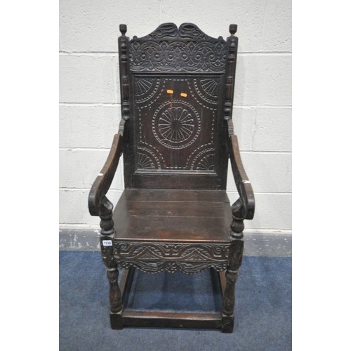 1535 - AN 18TH CENTURY CARVED OAK WAINSCOTE CHAIR, with scrolls surrounding a geometric decorated panel, op... 