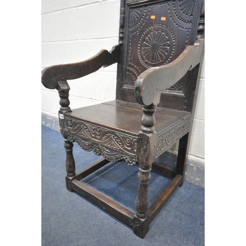 1535 - AN 18TH CENTURY CARVED OAK WAINSCOTE CHAIR, with scrolls surrounding a geometric decorated panel, op... 