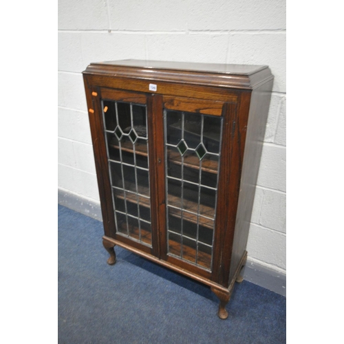 1540 - AN OAK LEAD GLAZED TWO DOOR BOOKCASE, on cabriole legs, width 76cm x depth 30cm x height 117cm