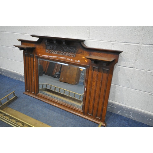 1542 - AN EARLY 20TH CENTURY OAK OVERMANTEL MIRROR, with a bevelled glass plate, 137cm x 90cm, and a brass ... 