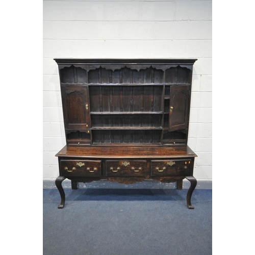 1548 - A GEORGIAN OAK DRESSER, the top with an arrangement of shelving flanked by a single cupboard, above ... 