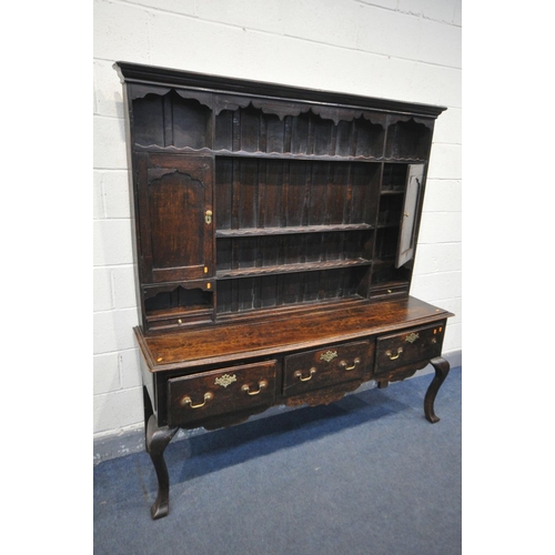 1548 - A GEORGIAN OAK DRESSER, the top with an arrangement of shelving flanked by a single cupboard, above ... 