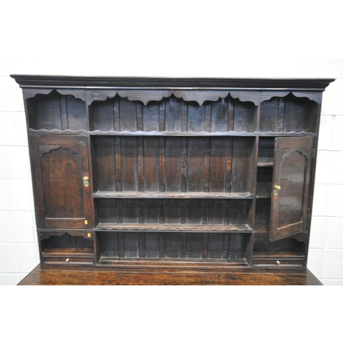 1548 - A GEORGIAN OAK DRESSER, the top with an arrangement of shelving flanked by a single cupboard, above ... 