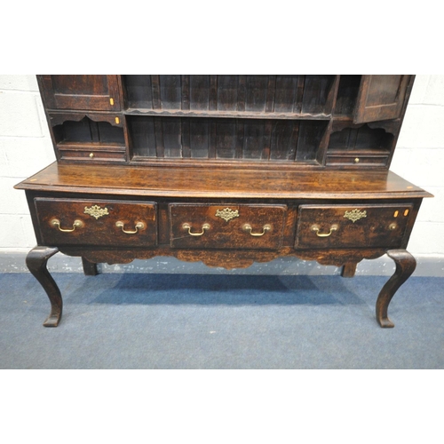 1548 - A GEORGIAN OAK DRESSER, the top with an arrangement of shelving flanked by a single cupboard, above ... 