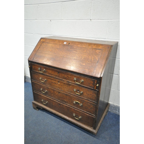 1549 - A GEORGIAN OAK AND BOX INLAID BUREAU, the fall front  enclosing a fitted interior, over four long dr... 