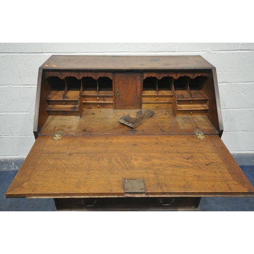 1549 - A GEORGIAN OAK AND BOX INLAID BUREAU, the fall front  enclosing a fitted interior, over four long dr... 