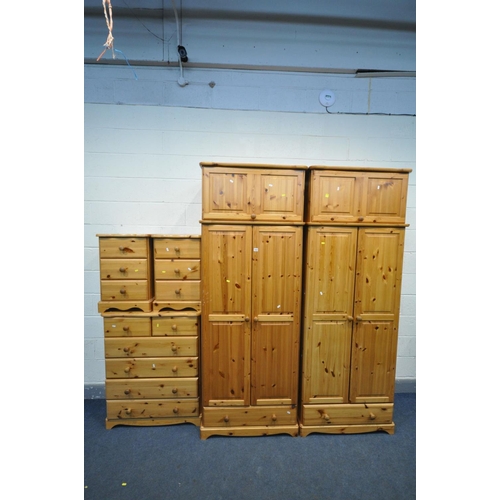 1553 - A PINE BEDROOM SUITE, comprising two double door wardrobes, with top boxes and a single drawer, widt... 