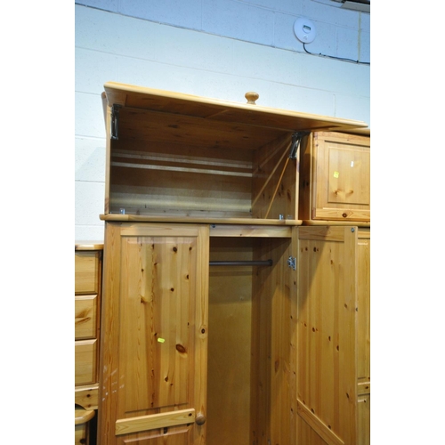 1553 - A PINE BEDROOM SUITE, comprising two double door wardrobes, with top boxes and a single drawer, widt... 