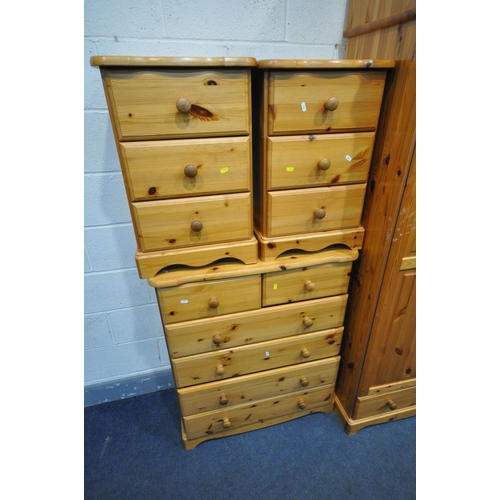 1553 - A PINE BEDROOM SUITE, comprising two double door wardrobes, with top boxes and a single drawer, widt... 