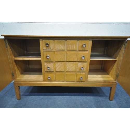 1566 - A GORDON RUSSELL OF BROADWAY 1960'S SIDEBOARD, with cupboard doors flanking four drawers, the top dr... 