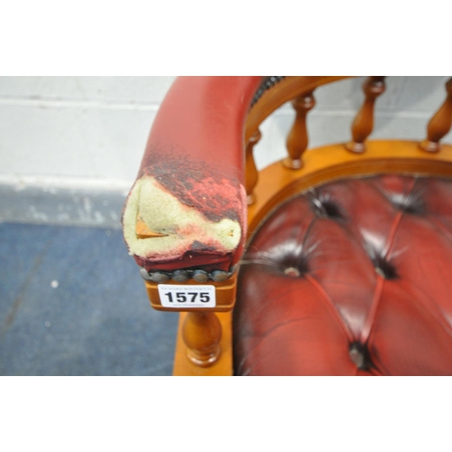 1575 - AN OXBLOOD LEATHER BUTTONED CAPTAINS CHAIR (condition - torn and missing leather to right arm)