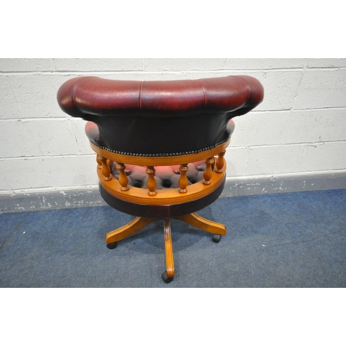 1575 - AN OXBLOOD LEATHER BUTTONED CAPTAINS CHAIR (condition - torn and missing leather to right arm)