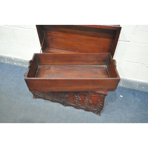 1580 - A HEAVILY CARVED HARDWOOD REPRODUCTION CHEST, with an internal removable tray and two dividers, leng... 